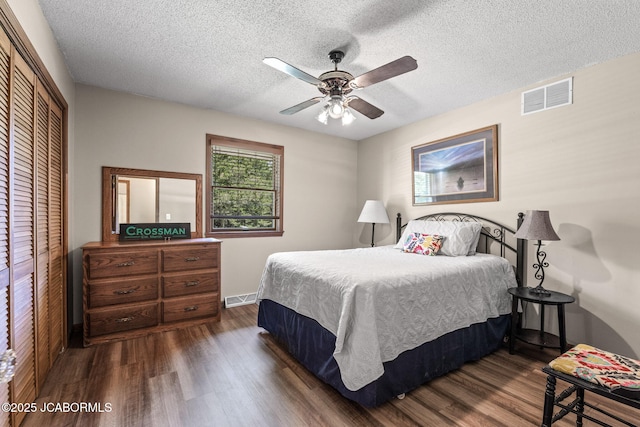 bedroom with visible vents, a closet, and dark wood-style flooring