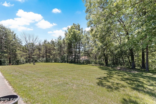 view of yard with a view of trees