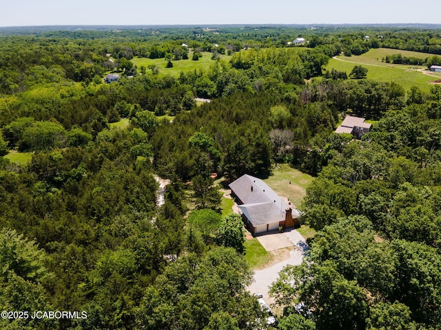 birds eye view of property featuring a view of trees