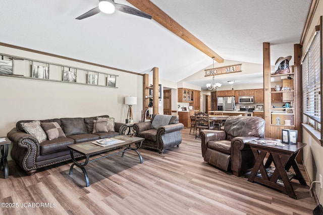 living area with ceiling fan with notable chandelier, vaulted ceiling with beams, and light wood finished floors