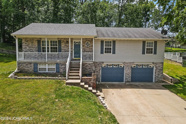 view of front of property with a porch, a garage, and a front lawn