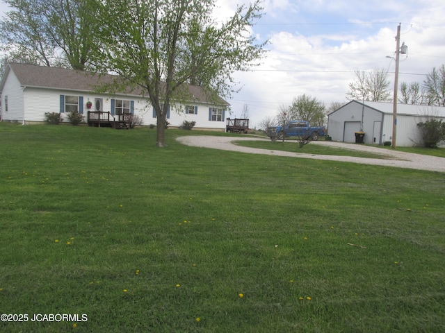 view of yard with an outbuilding, driveway, and a deck