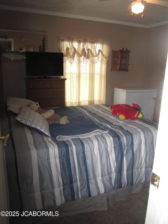 bedroom with ornamental molding and carpet