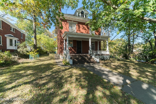 view of front of house with a front yard and a porch