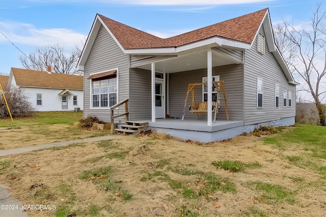 rear view of house featuring a porch