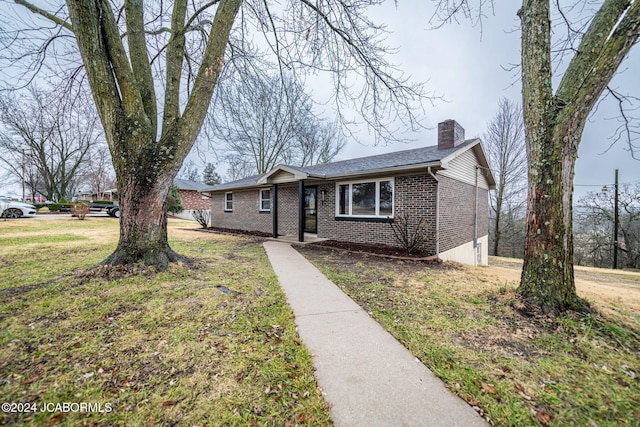 ranch-style home with a front yard