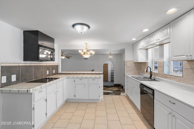 kitchen with white cabinets, black appliances, and a sink