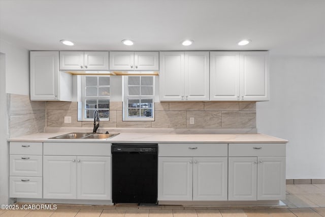 kitchen with a sink, decorative backsplash, black dishwasher, and light countertops