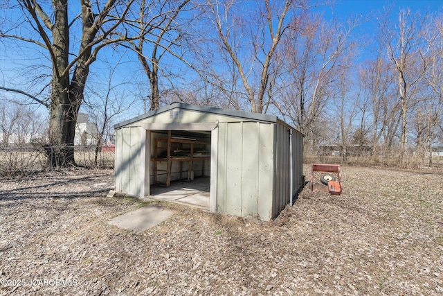 view of shed featuring fence