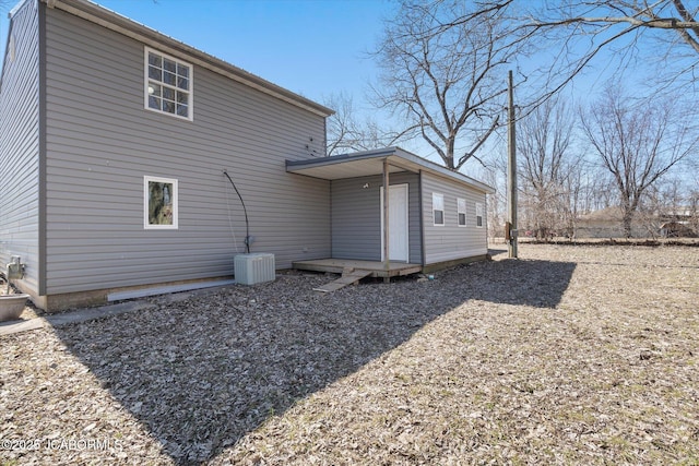 rear view of house with central AC unit