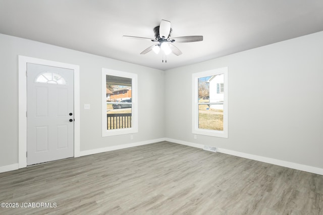 foyer with wood finished floors, visible vents, and a healthy amount of sunlight