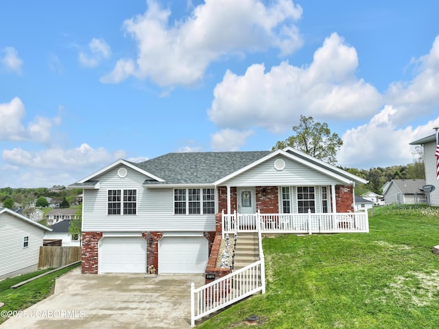 view of front of property with covered porch, driveway, a front yard, a garage, and brick siding