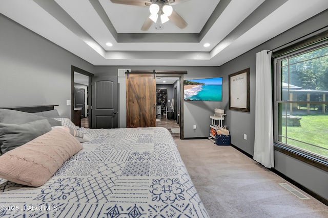 11169 Ridge Fork Dr, Holts Summit, MO 65043 - bedroom featuring light carpet, a barn door, a tray ceiling, and recessed lighting