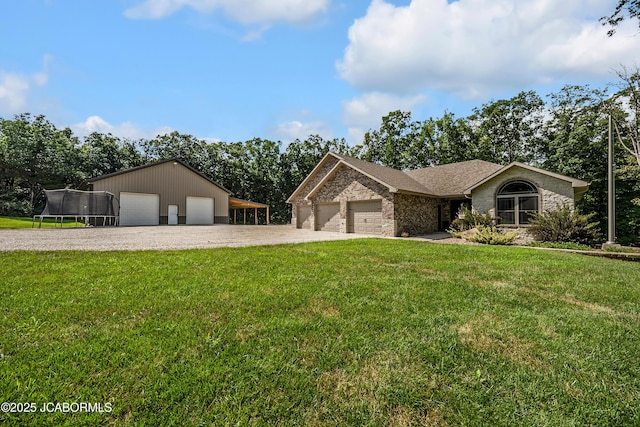 11169 Ridge Fork Dr, Holts Summit, MO 65043 - single story home featuring a trampoline, driveway, a front lawn, and a detached garage