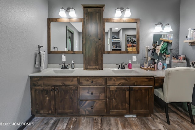 11169 Ridge Fork Dr, Holts Summit, MO 65043 - full bath featuring a textured wall, double vanity, and wood finished floors