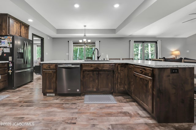 11169 Ridge Fork Dr, Holts Summit, MO 65043 - kitchen with dishwasher, refrigerator with ice dispenser, a raised ceiling, dark brown cabinetry, and recessed lighting