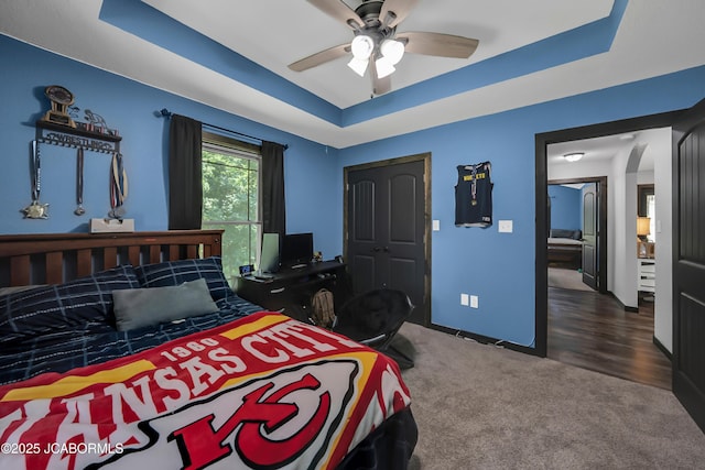 11169 Ridge Fork Dr, Holts Summit, MO 65043 - bedroom featuring a raised ceiling, carpet flooring, and ceiling fan
