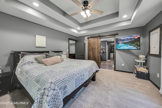 11169 Ridge Fork Dr, Holts Summit, MO 65043 - carpeted bedroom with a tray ceiling, a barn door, recessed lighting, and ceiling fan