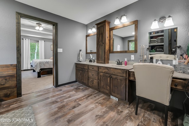 11169 Ridge Fork Dr, Holts Summit, MO 65043 - ensuite bathroom with wood finished floors, double vanity, a ceiling fan, and a textured wall
