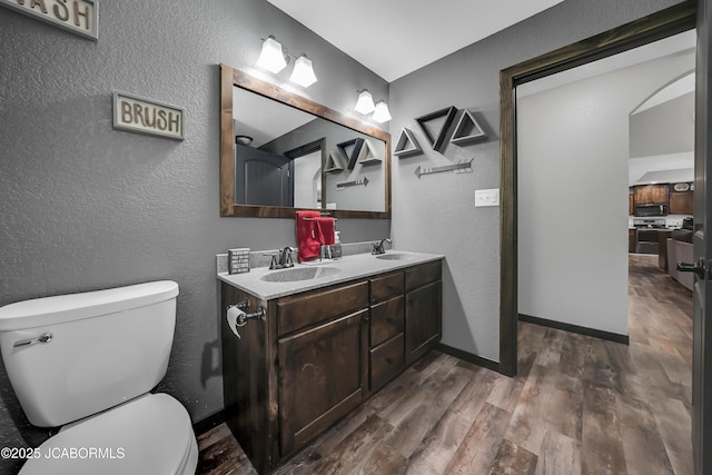 11169 Ridge Fork Dr, Holts Summit, MO 65043 - bathroom featuring double vanity, wood finished floors, and a textured wall