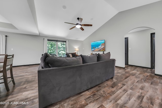 11169 Ridge Fork Dr, Holts Summit, MO 65043 - living area featuring lofted ceiling, ceiling fan, arched walkways, and wood finished floors