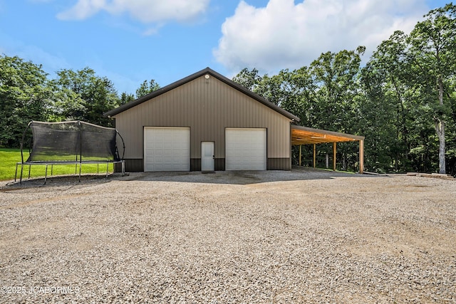 11169 Ridge Fork Dr, Holts Summit, MO 65043 - garage featuring a detached garage and a trampoline