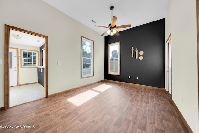 822 Center St, Fulton, MO 65251 - empty room with light wood-type flooring, healthy amount of natural light, and a ceiling fan