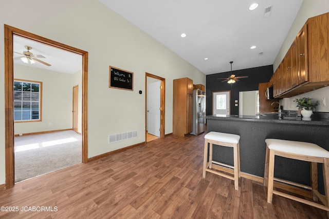 822 Center St, Fulton, MO 65251 - kitchen featuring a ceiling fan, wood finished floors, dark countertops, recessed lighting, and vaulted ceiling