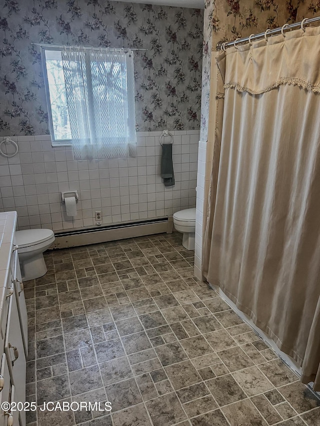 full bathroom featuring wallpapered walls, a baseboard radiator, and wainscoting