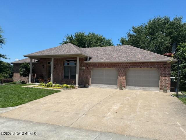508 Morgan St, California, MO 65018 - ranch-style house featuring an attached garage, driveway, a front lawn, and brick siding