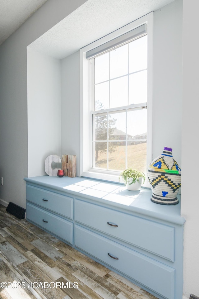 mudroom featuring a textured ceiling and dark wood finished floors