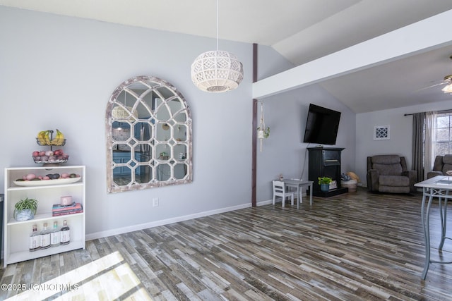 interior space featuring lofted ceiling, baseboards, and wood finished floors