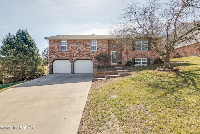 split foyer home with a garage, a front yard, concrete driveway, and brick siding