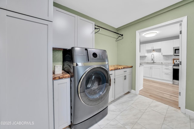 53036 Bird Haven Rd, Centertown, MO 65023 - laundry room with washer / clothes dryer, cabinet space, and light marble finish flooring