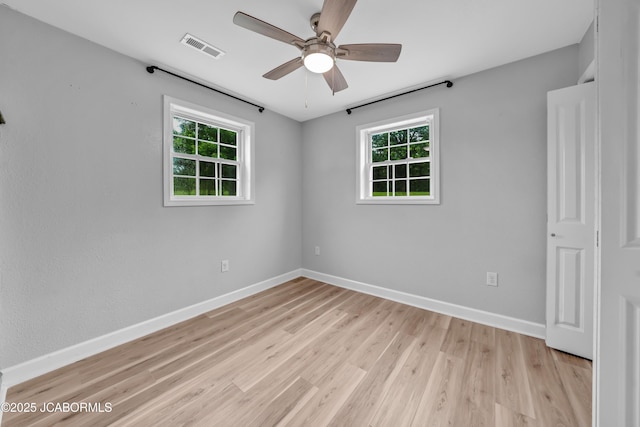 53036 Bird Haven Rd, Centertown, MO 65023 - empty room featuring plenty of natural light, a ceiling fan, and light wood-style flooring