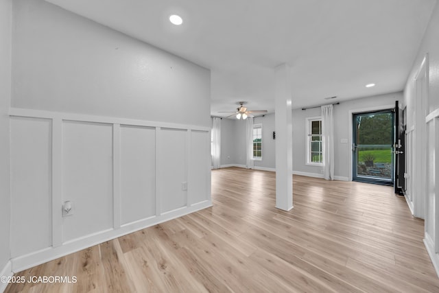53036 Bird Haven Rd, Centertown, MO 65023 - unfurnished living room featuring a decorative wall, ceiling fan, light wood-style flooring, recessed lighting, and wainscoting