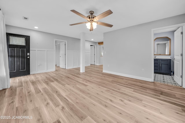 53036 Bird Haven Rd, Centertown, MO 65023 - unfurnished living room featuring ceiling fan, light wood-style floors, recessed lighting, and a wainscoted wall