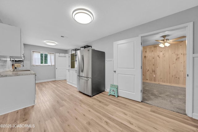 53036 Bird Haven Rd, Centertown, MO 65023 - kitchen featuring freestanding refrigerator, white cabinetry, light wood finished floors, and light countertops