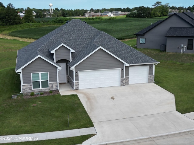 view of front of property with a garage and a front lawn