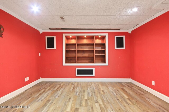 907 Primrose Ln, Jefferson City, MO 65109 - empty room with built in shelves, crown molding, and wood finished floors