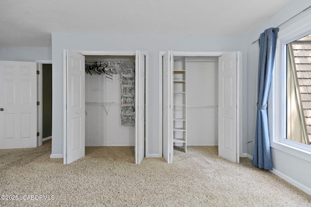 907 Primrose Ln, Jefferson City, MO 65109 - unfurnished bedroom with multiple closets and carpet flooring