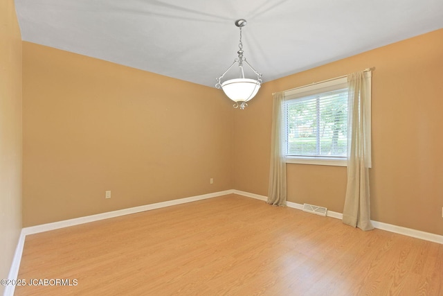 907 Primrose Ln, Jefferson City, MO 65109 - unfurnished room with light wood finished floors and baseboards