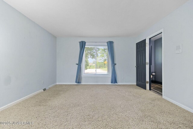 907 Primrose Ln, Jefferson City, MO 65109 - carpeted empty room with baseboards
