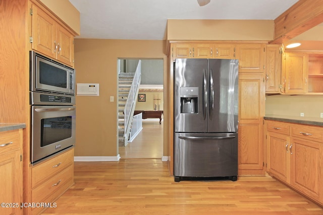 907 Primrose Ln, Jefferson City, MO 65109 - kitchen with appliances with stainless steel finishes, light wood-style floors, and open shelves