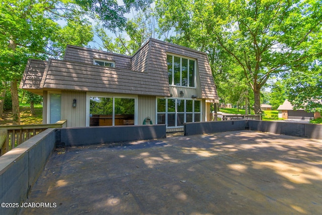 907 Primrose Ln, Jefferson City, MO 65109 - back of property with mansard roof and a patio