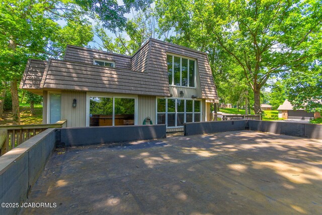 907 Primrose Ln, Jefferson City, MO 65109 - back of property with mansard roof and a patio