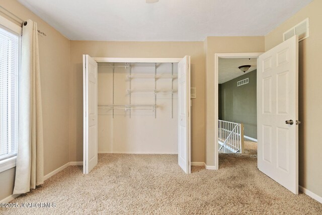 907 Primrose Ln, Jefferson City, MO 65109 - unfurnished bedroom featuring carpet and a closet