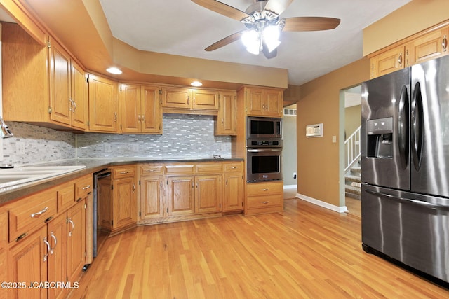 907 Primrose Ln, Jefferson City, MO 65109 - kitchen with appliances with stainless steel finishes, backsplash, light wood finished floors, and ceiling fan
