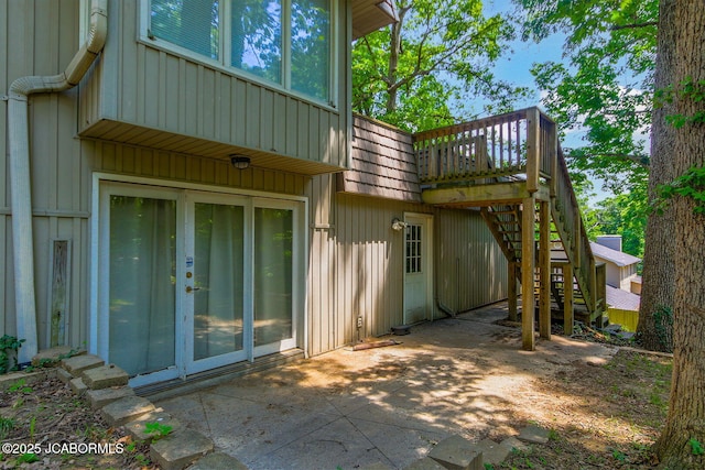 907 Primrose Ln, Jefferson City, MO 65109 - back of property featuring stairway, mansard roof, a patio area, a wooden deck, and board and batten siding