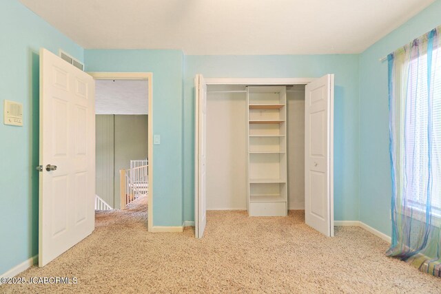 907 Primrose Ln, Jefferson City, MO 65109 - unfurnished bedroom with carpet, a closet, and multiple windows